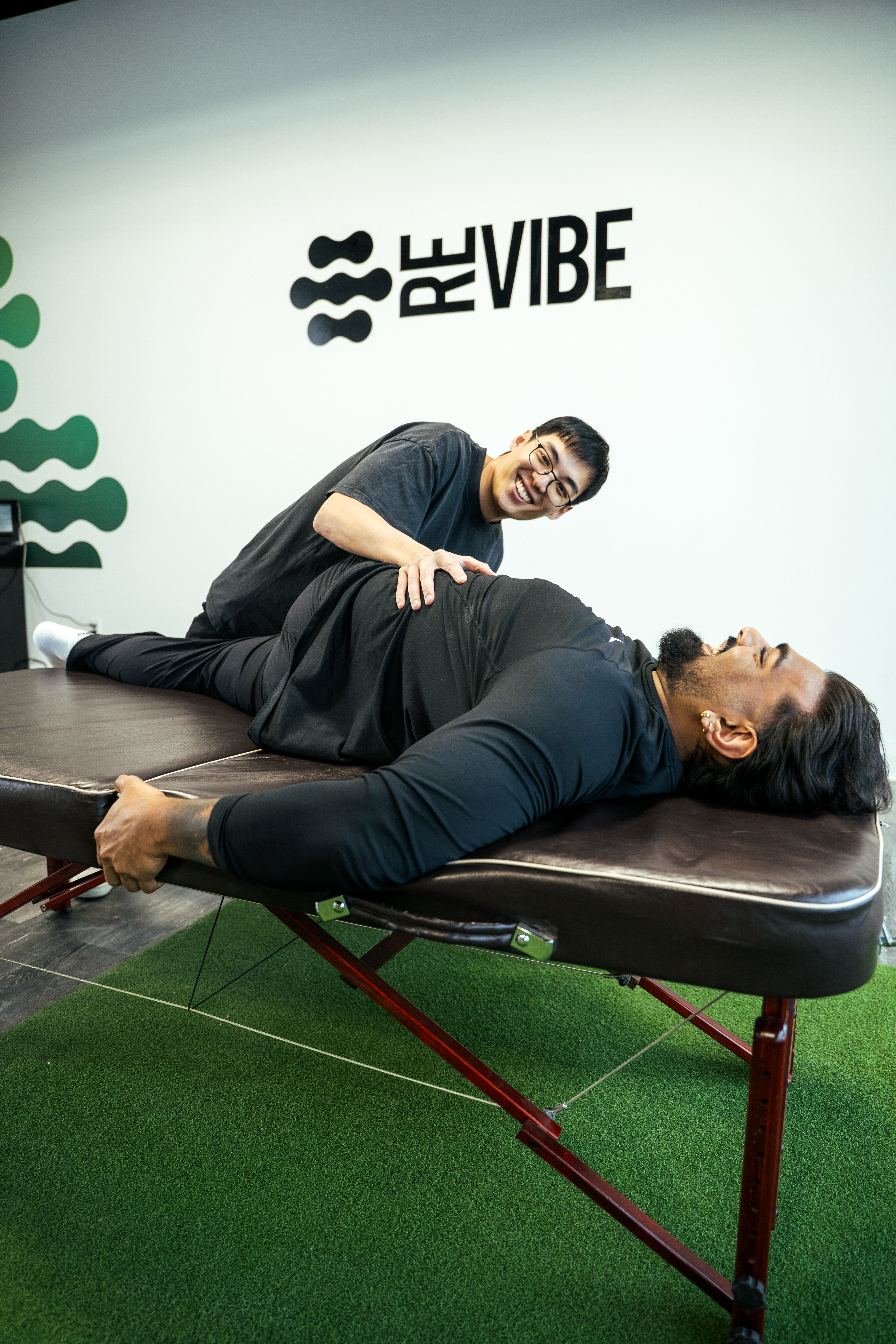 Therapist performing a manual adjustment on a patient's back.