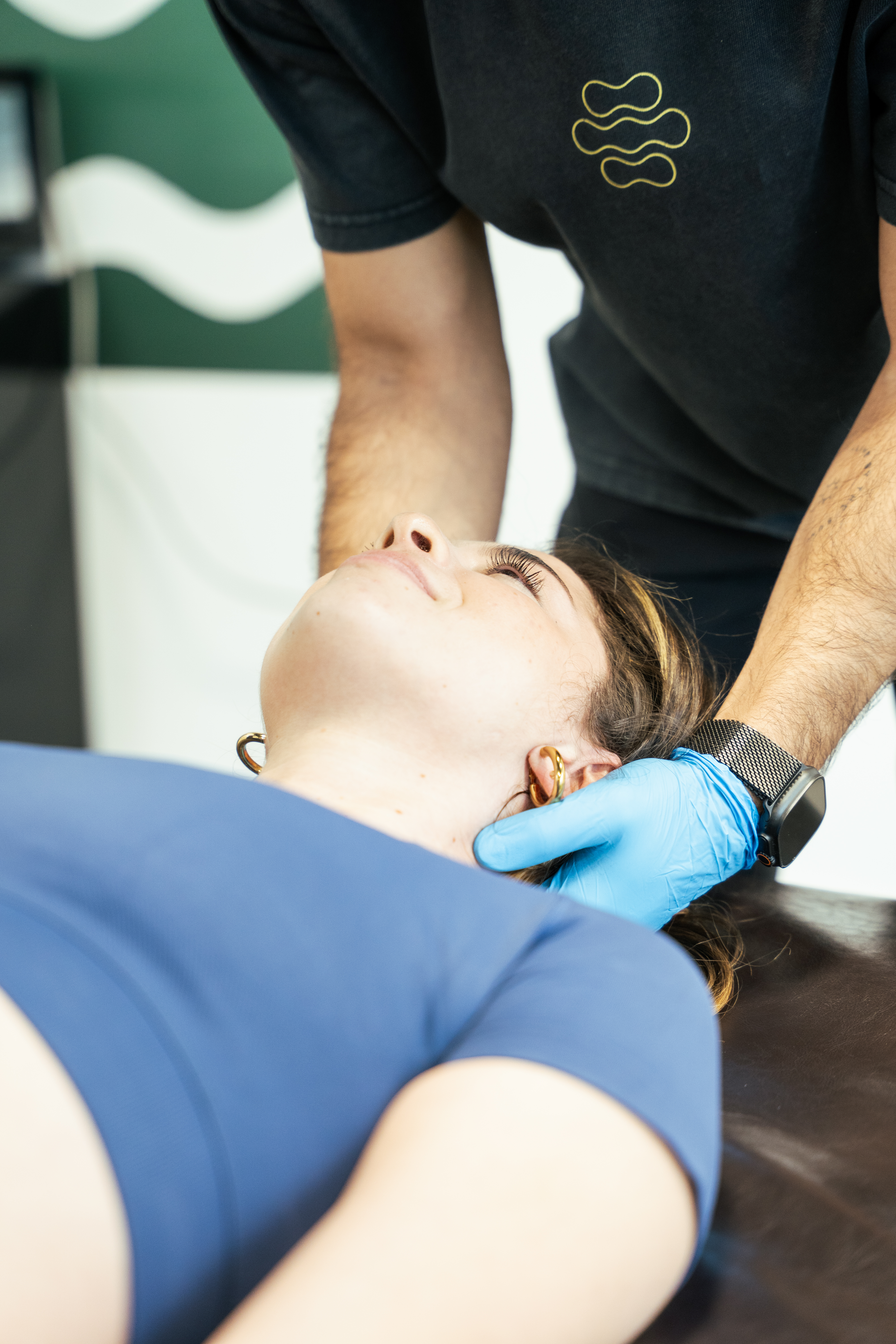 Close-up of a chiropractor gently adjusting a patient’s neck.