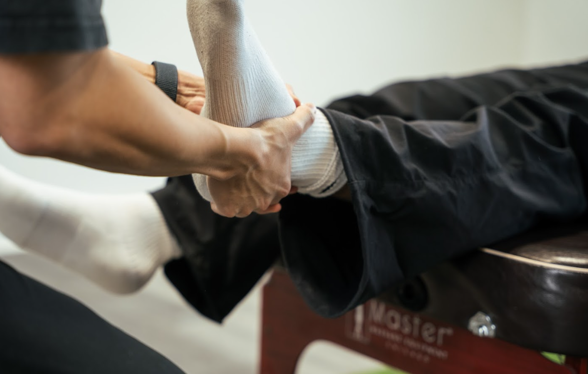 Chiropractic joint manipulation for ankle mobility and recovery.